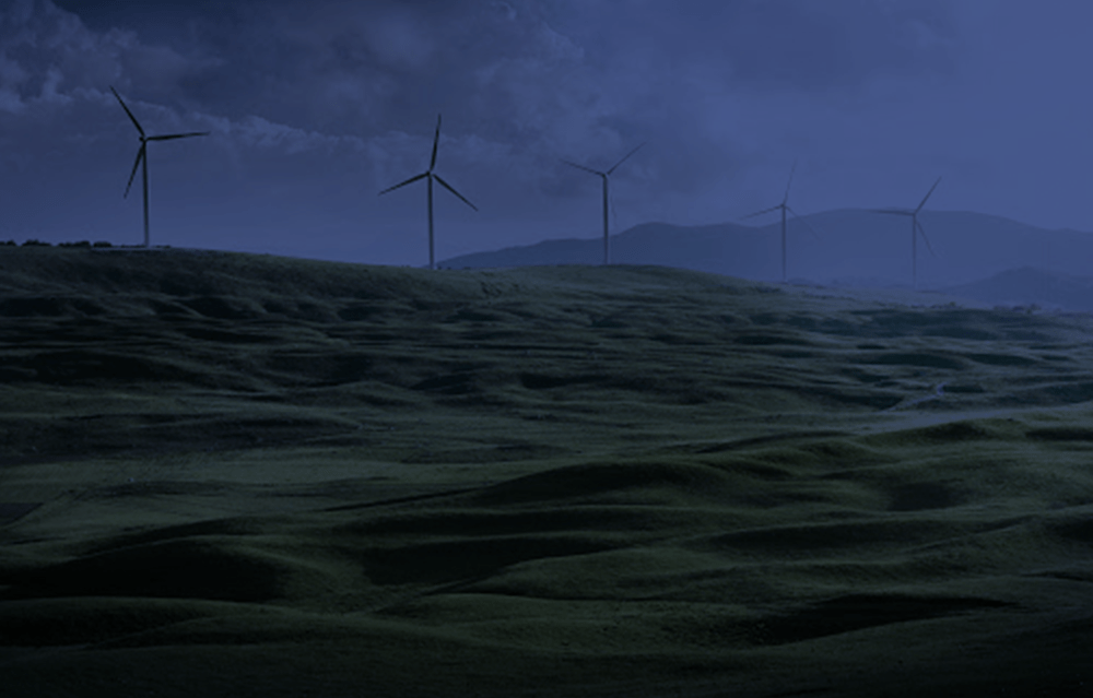 Wind turbines in an open field showcasing YVSM's environmental, natural resources and sustainability practice area.
